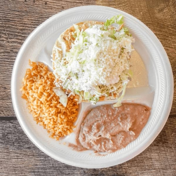 Antonio's Quick Lunch Mexican combo plate with a tostada, rice, and refried beans.